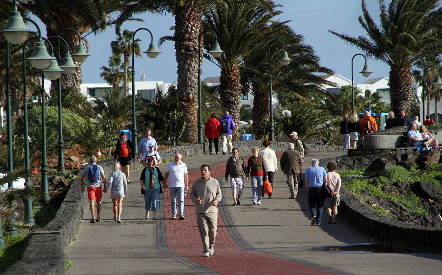 Seafront promenade in Costa Teguise, Lanzarote, with palm trees and ocean views