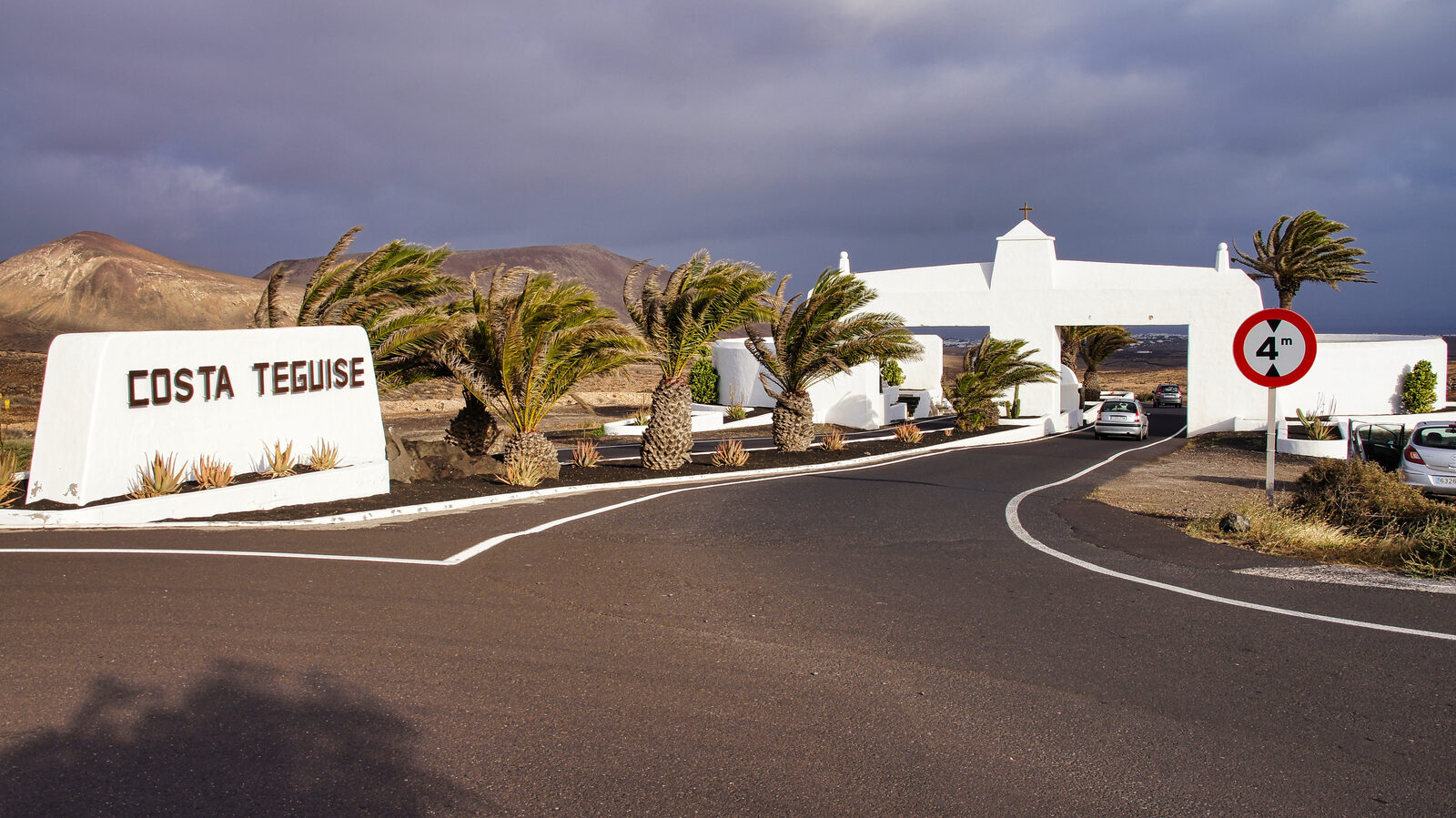 Aerial view of Costa Teguise resort along the east coast of Lanzarote with low-rise buildings and palm-lined avenues