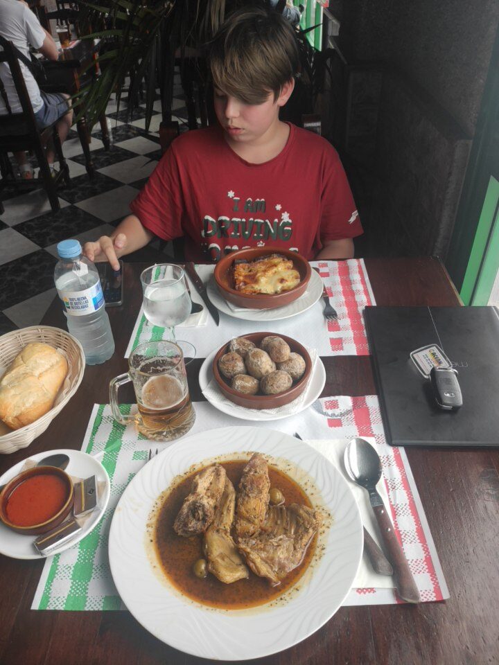 Conejo en salmorejo, Canarian-style marinated rabbit stew, on a white plate with sauce, Lanzarote