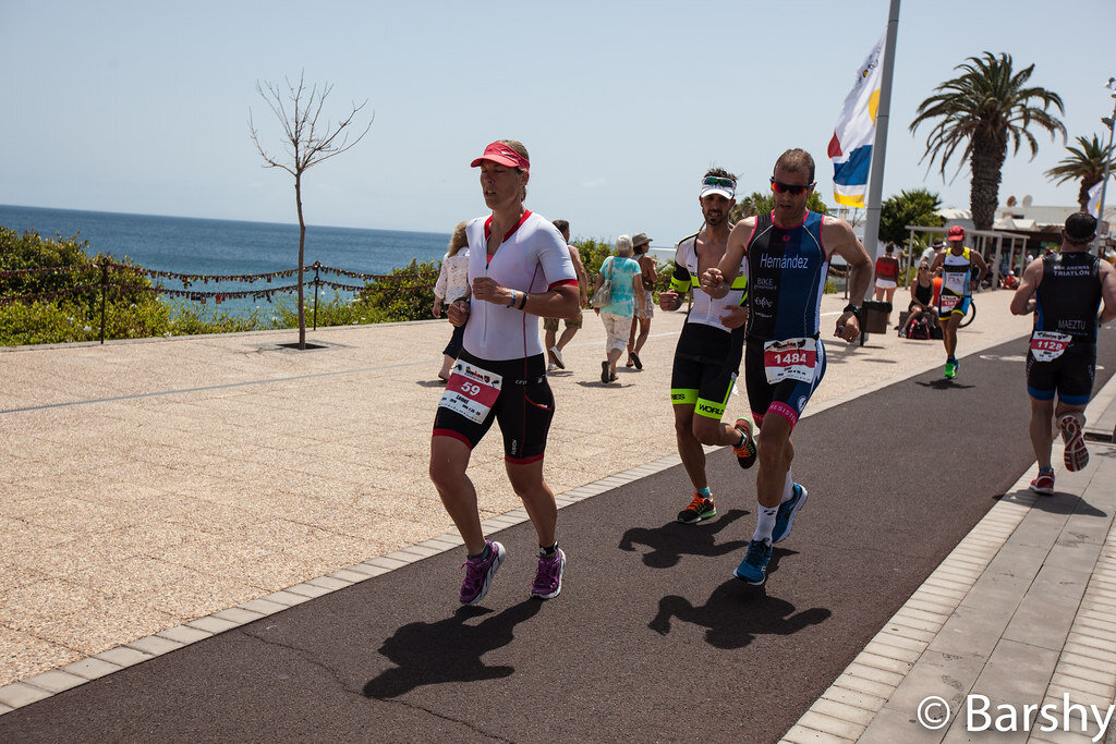 Runners on the Avenida de las Playas seafront promenade during Ironman Lanzarote