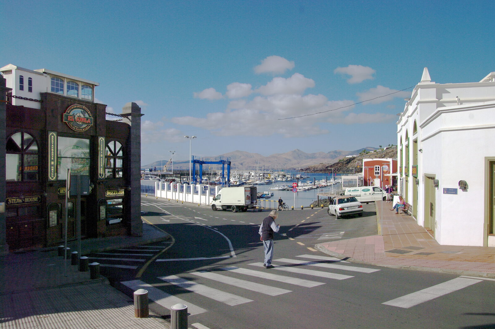 Old harbour at Puerto del Carmen with fishing boats and a small lighthouse