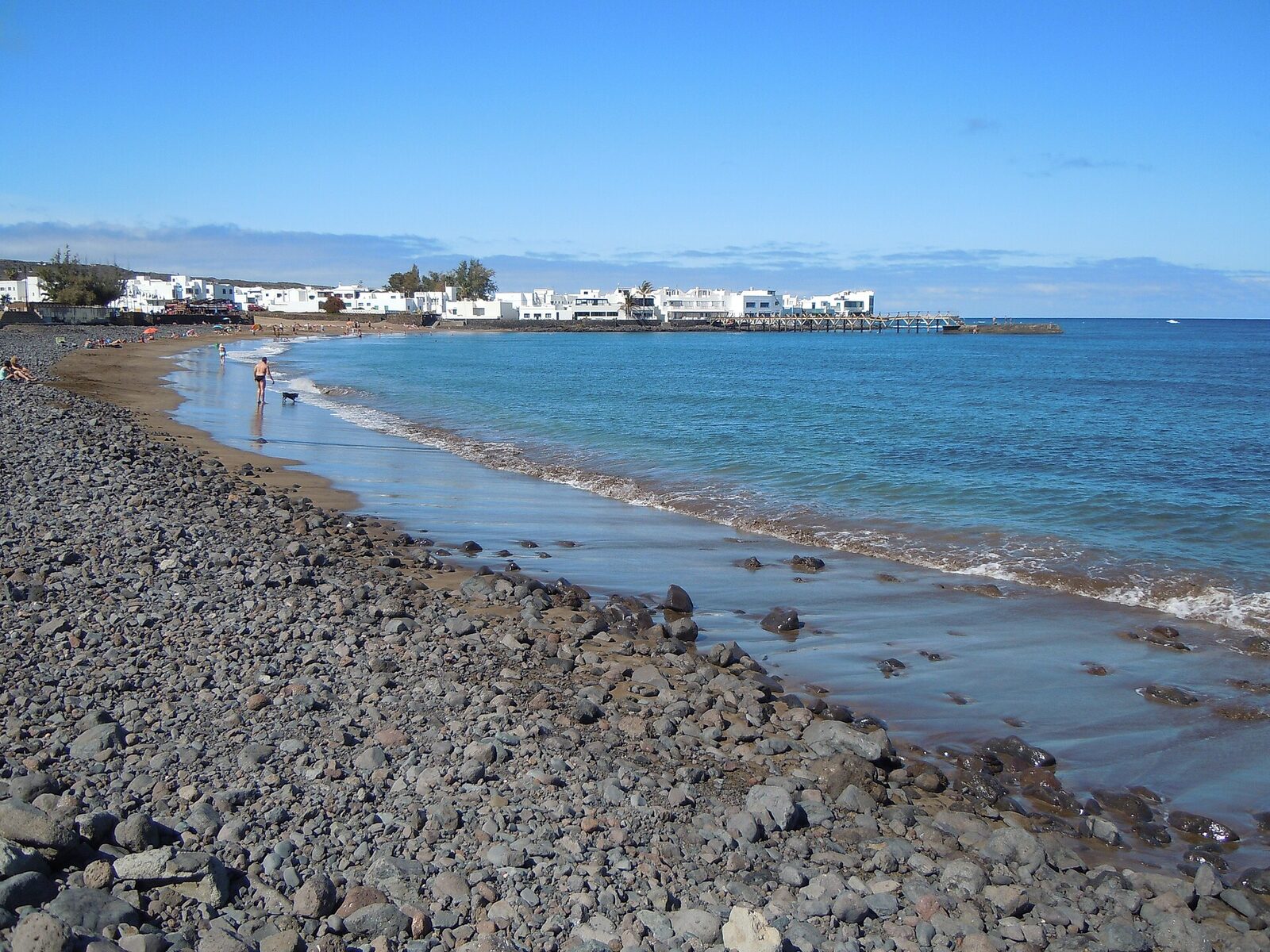 Playa de la Garita in Arrieta, a long sandy family beach on Lanzarote's northeast coast with pier and promenade