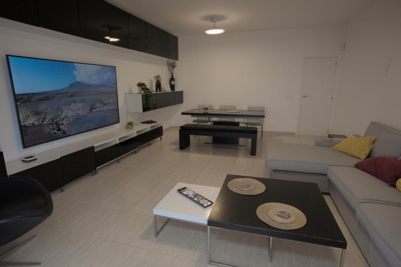 Living room with large TV and dining area